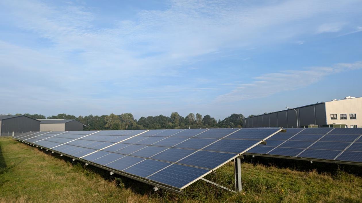 Ground-mounted solar panels beside a Hartford, CT commercial building, illustrating a large-scale business solar system.
