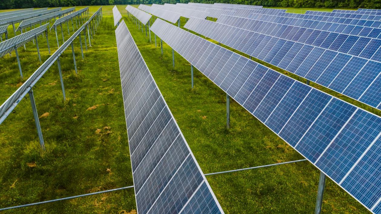 Rows of commercial ground-mounted solar panels on open land in Hartford, CT.